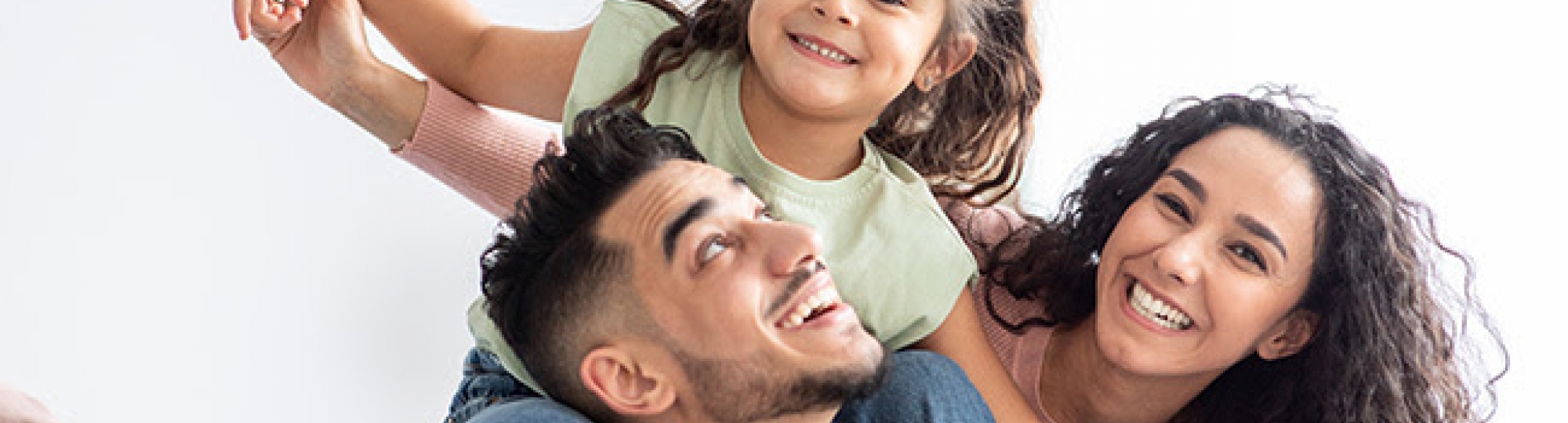 family with little girl on shoulders