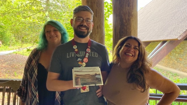 Josh with his award and co-workers