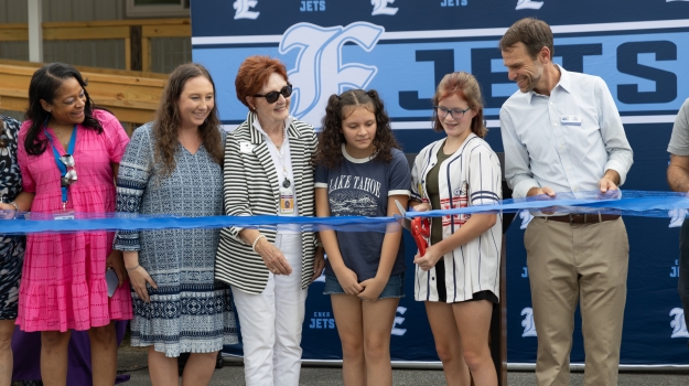 Takina Jones-Thomas, Amberle Clarke, Judy Lewis, Catalina, Meagan, and Dan Leroy at Enka Health Hanger ribbon cutting